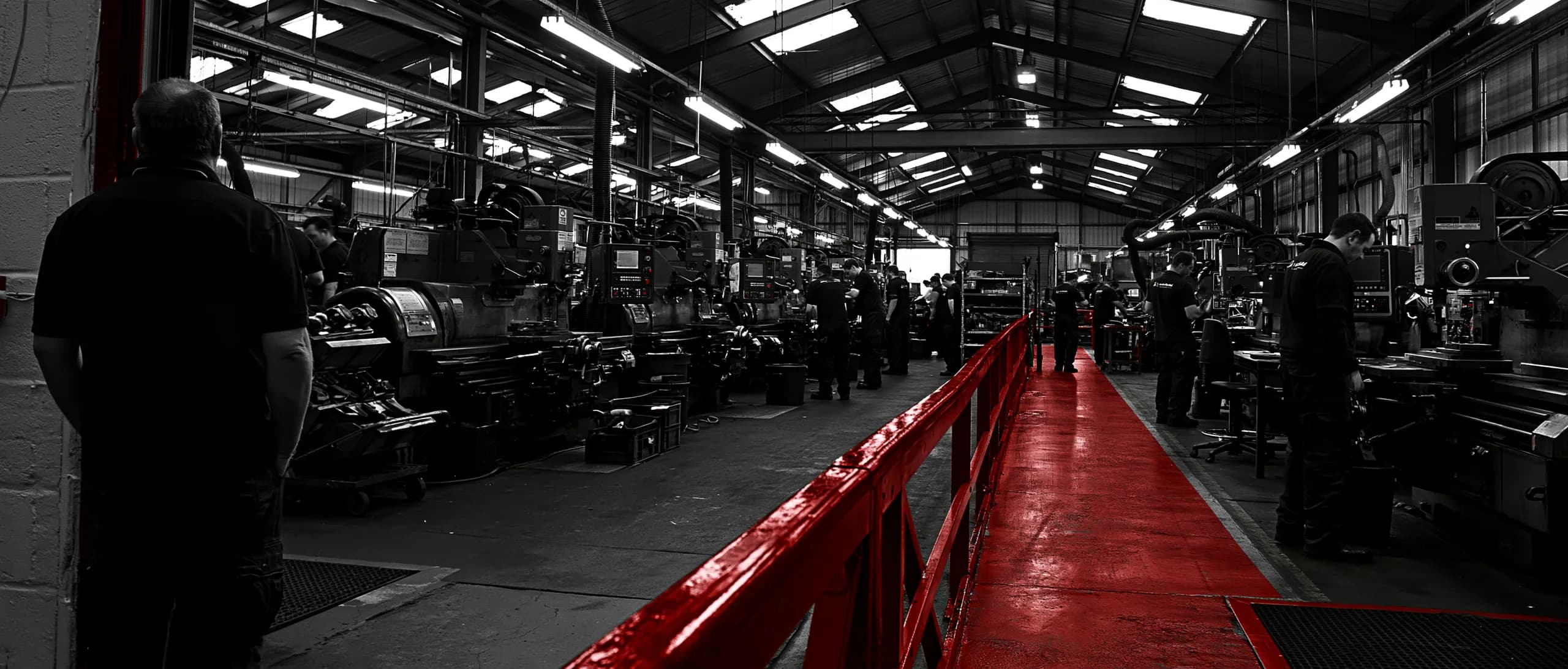 A business owner looking across the working shop floor they built